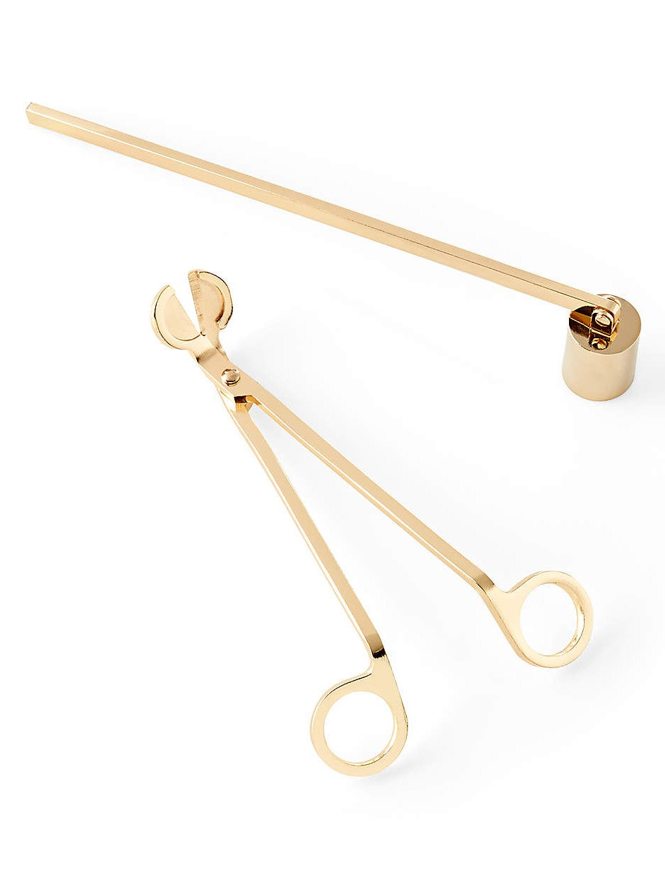 A luxury two-piece candle care set in a high-polish gold finish. The tools are on a white background which highlights their polish. The set includes a wick trimmer amd a candle snuffer with a pivoting head all featuring sleek, ergonomic handles and a minimalist, luxury aesthetic. Perfect as a hostess gift.