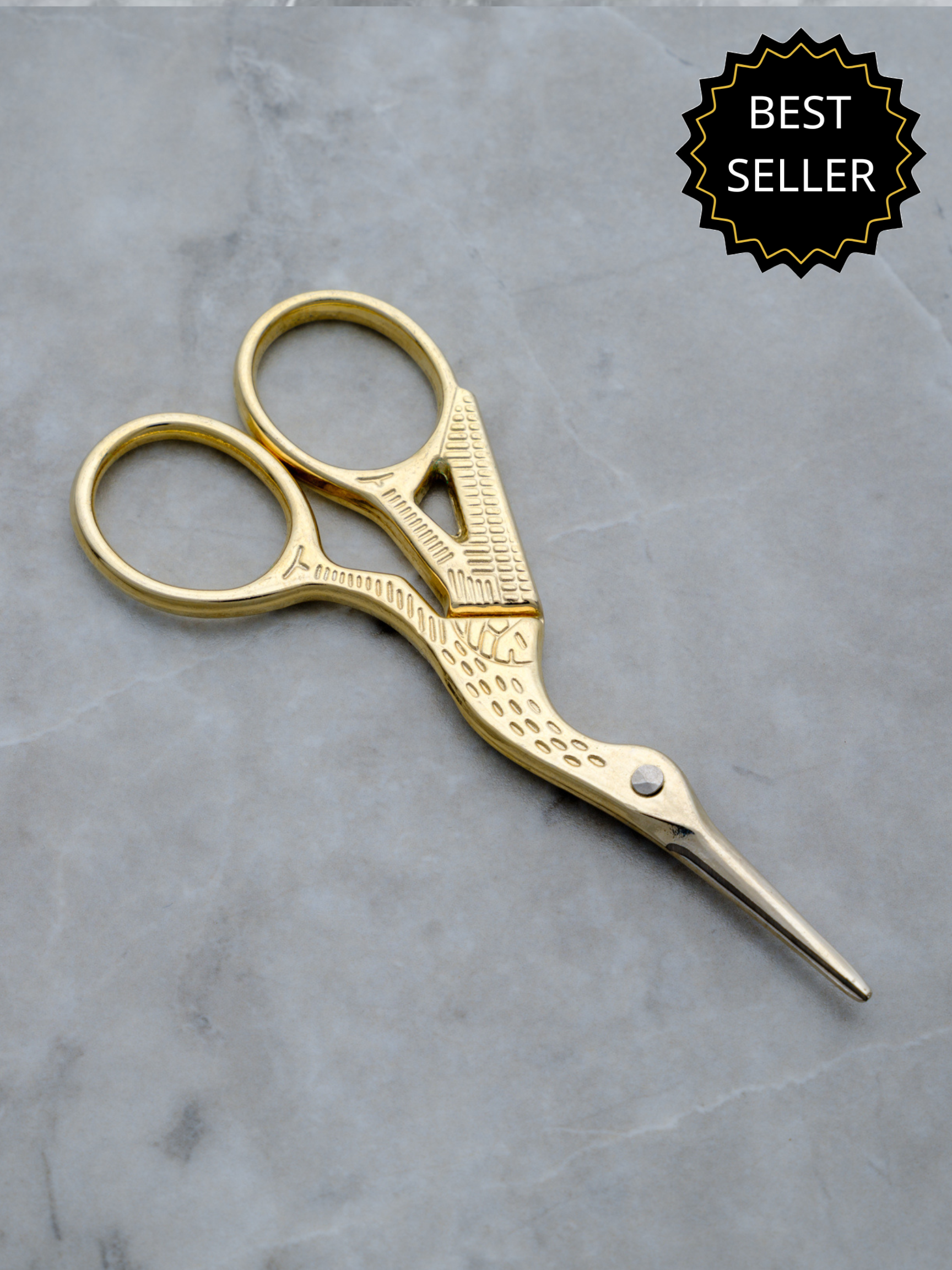 Rogue Paq gold cannabis trimming scissors in the shape of a crane bird for a refined smoking ritual. They are part of the extensive line of cute smoking accessories.