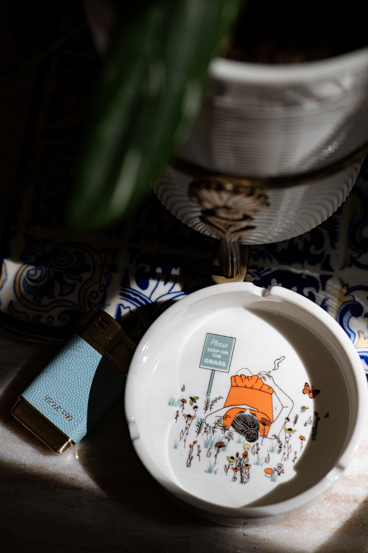 Our porcelain ashtray with intricate detail designed to add a touch of humor and style to your coffee table and decor.