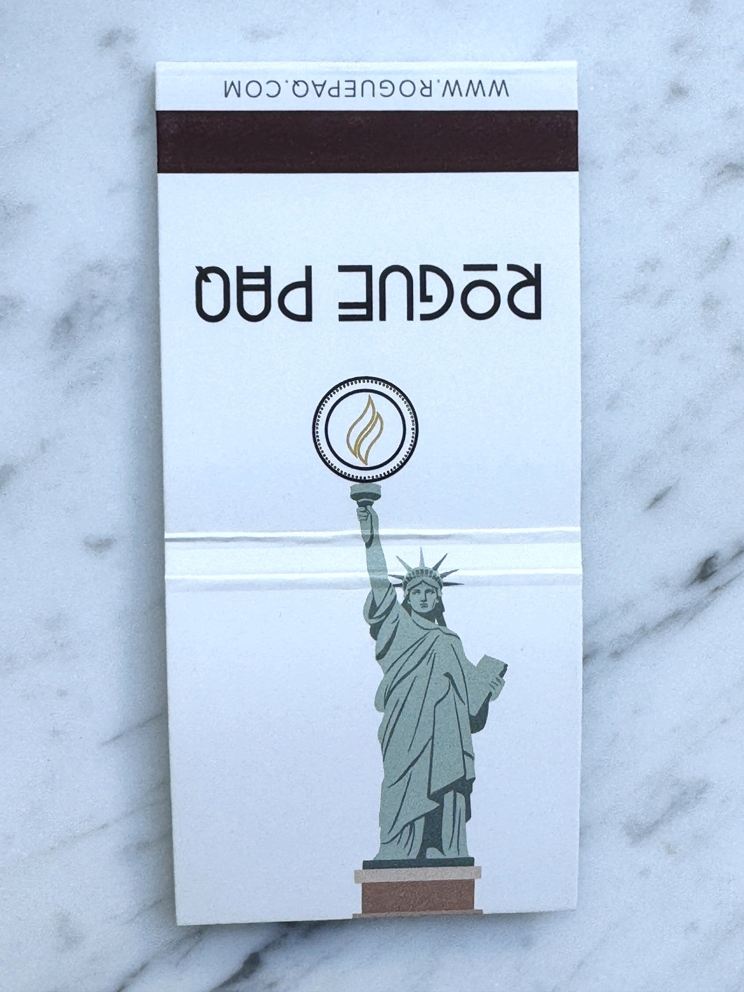 Close up of the cover of the Rogue Paq loves NY matches featuring the Statue of Liberty.