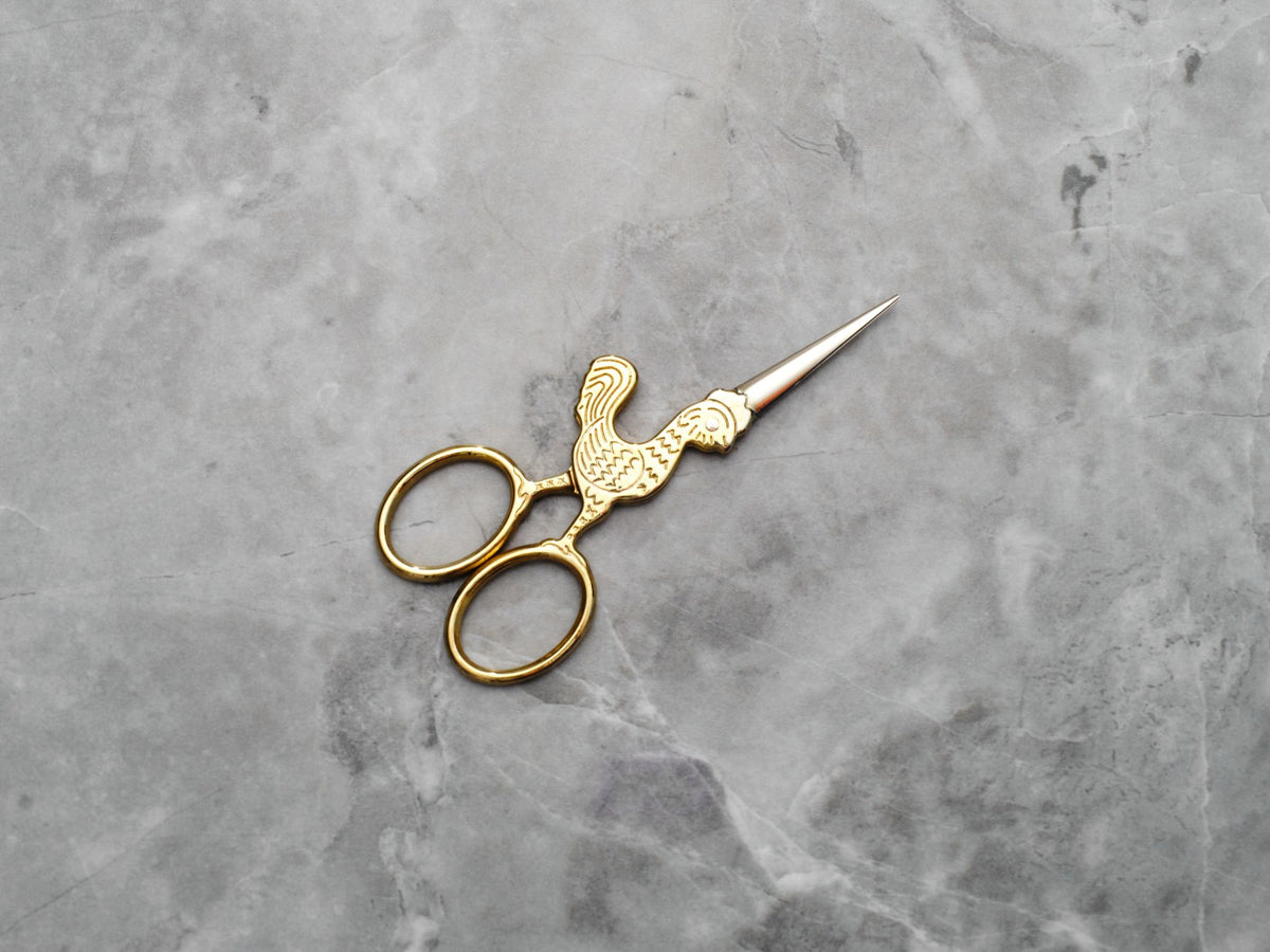 Small utility scissors with a whimsical rooster design make your ritual lighter and more fun.