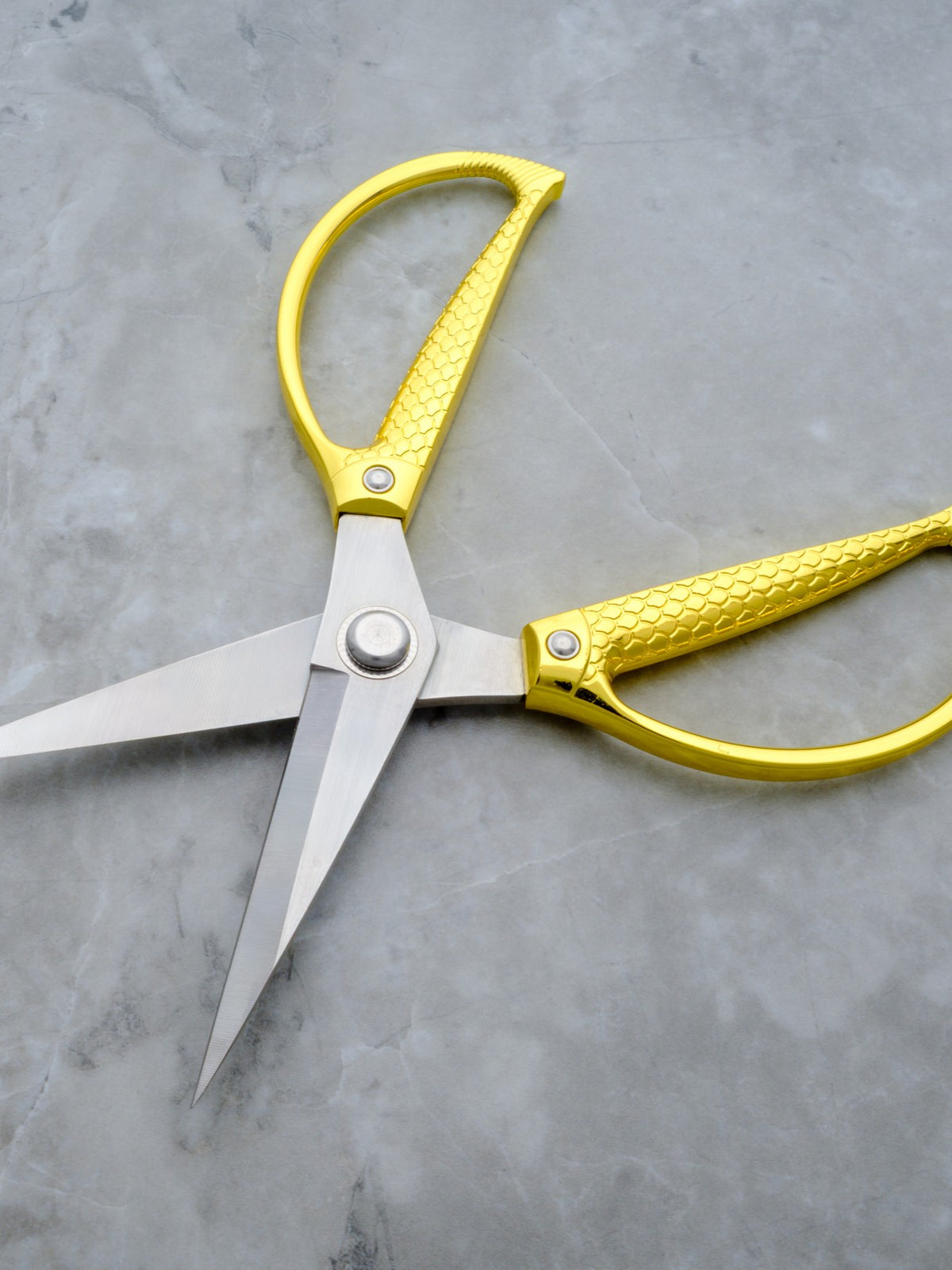 Rogue Paq XL gold cannabis trimming and harvesting scissors for a refined smoking ritual.