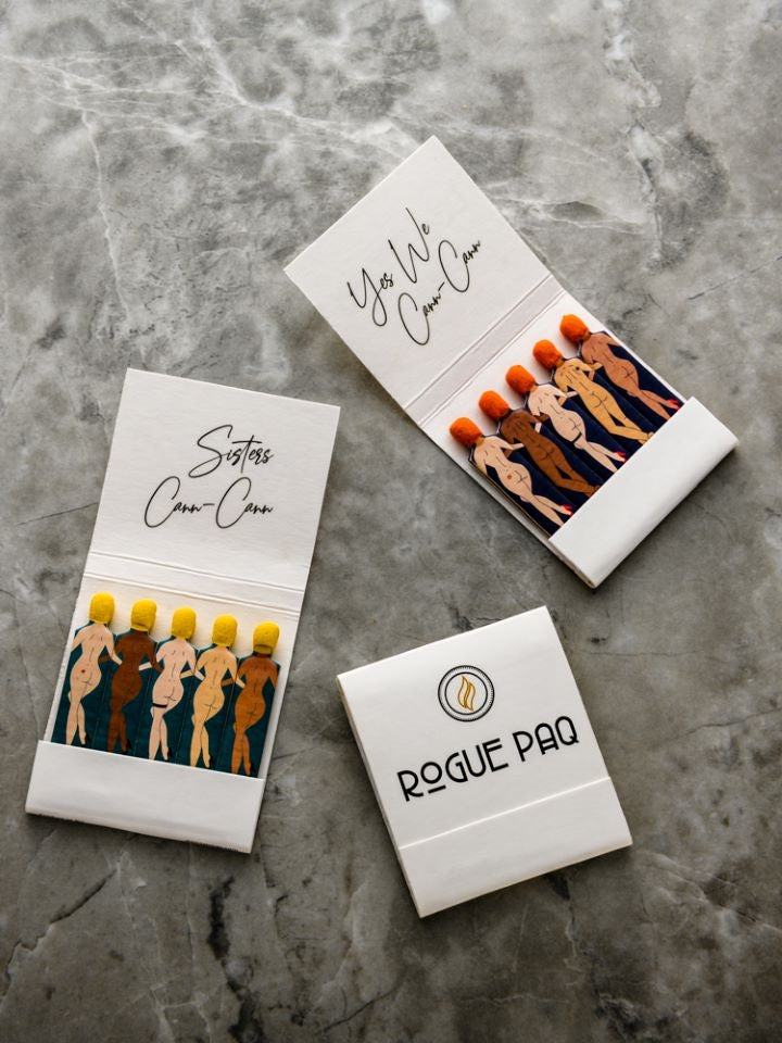A curated bundle of Rogue Paq SendNudes matchbooks. The set includes three 'Sisters Cann-Cann' and three 'Yes We Cann-Cann' matchbooks, featuring diverse, artistic pin-up figures in high-kick dance poses against a crisp white matchbook.