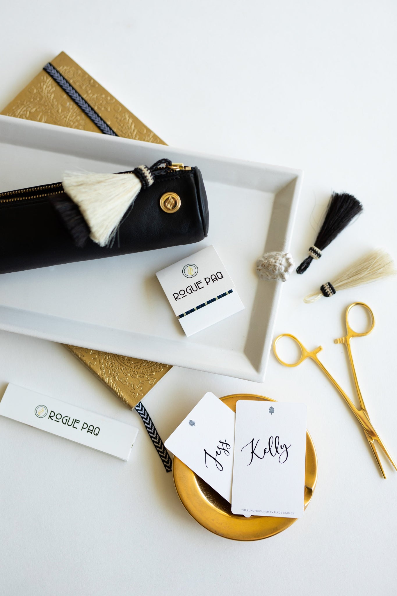The Rogue Paq x KellyGreen leather cannabis case presented on a white ceramic tray. The image highlights the shock-absorbent, thin-padded design of the scent-suppressant bag, curated for a sophisticated and private experience.