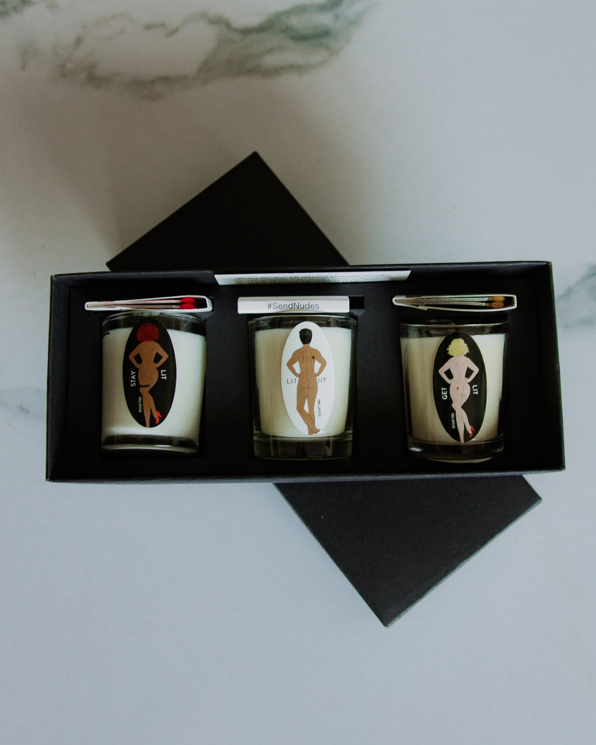 Top down shot of the SendNudes organic aromatherapy gift set with matches.