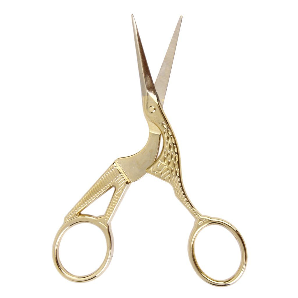 A close-up view of the intricate detailing on the crane scissors. The handles feature embossed feather textures and eye details, showcasing the vintage-inspired craftsmanship. The ergonomic finger loops are designed for comfort and precision during use in your cannabis ritual.
