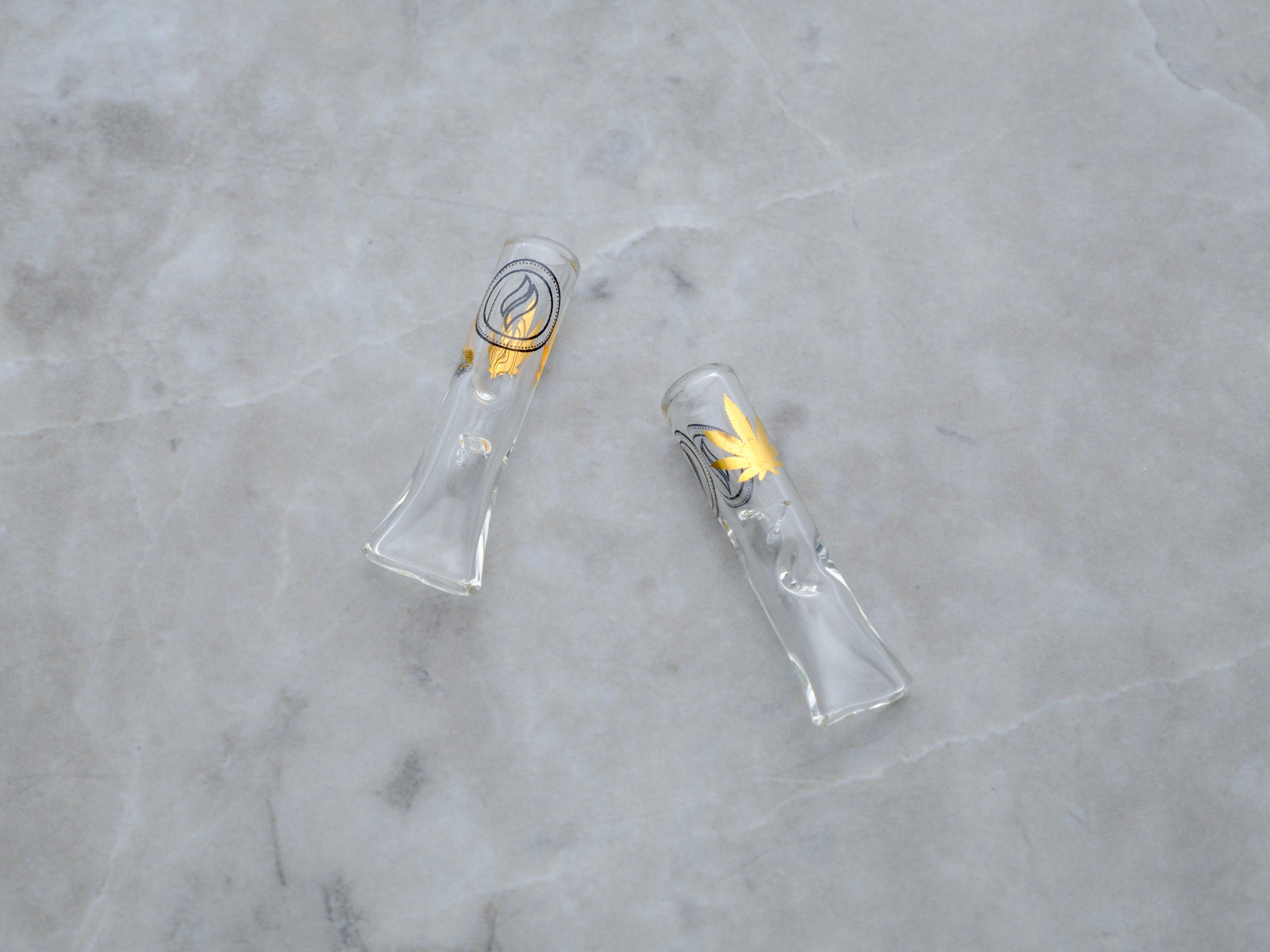 A pair of premium borosilicate glass rolling tips, also known as crutches, presented in a clean, minimalist 2-pack. Each tip features a sleek, transparent finish with the 'Rogue Paq' logo etched subtly in black serif typography