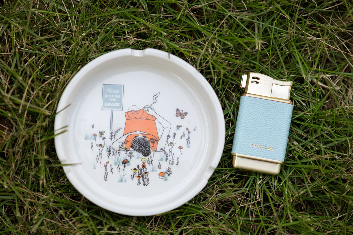 Please keep on the grass ashtray in the grass with our sky blue refillable lighter.