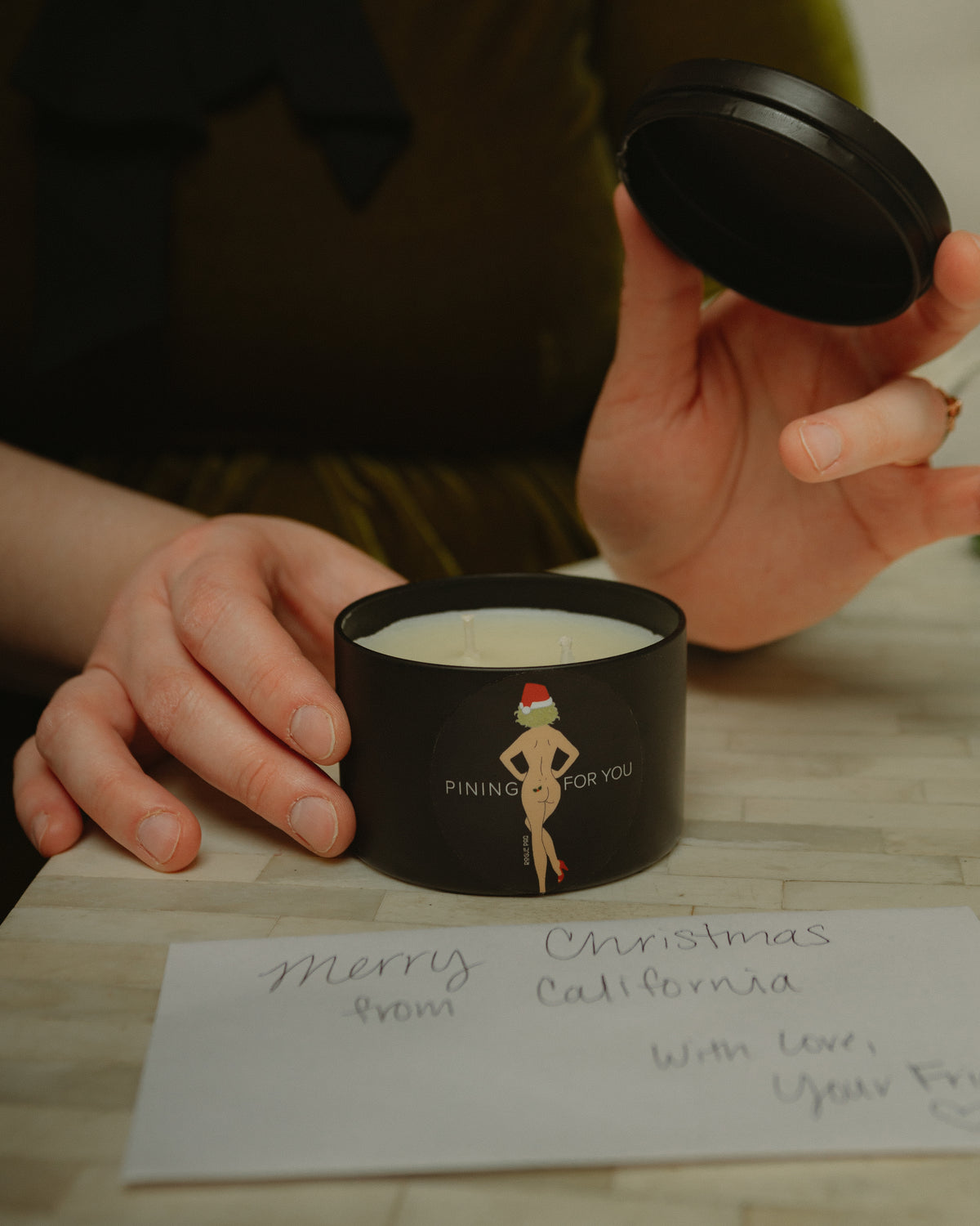 Top view of the 'Pining For You' candle showing the matching lid; designed to preserve the scent and allow the tin to be reused as a discreet stash jar after burning.