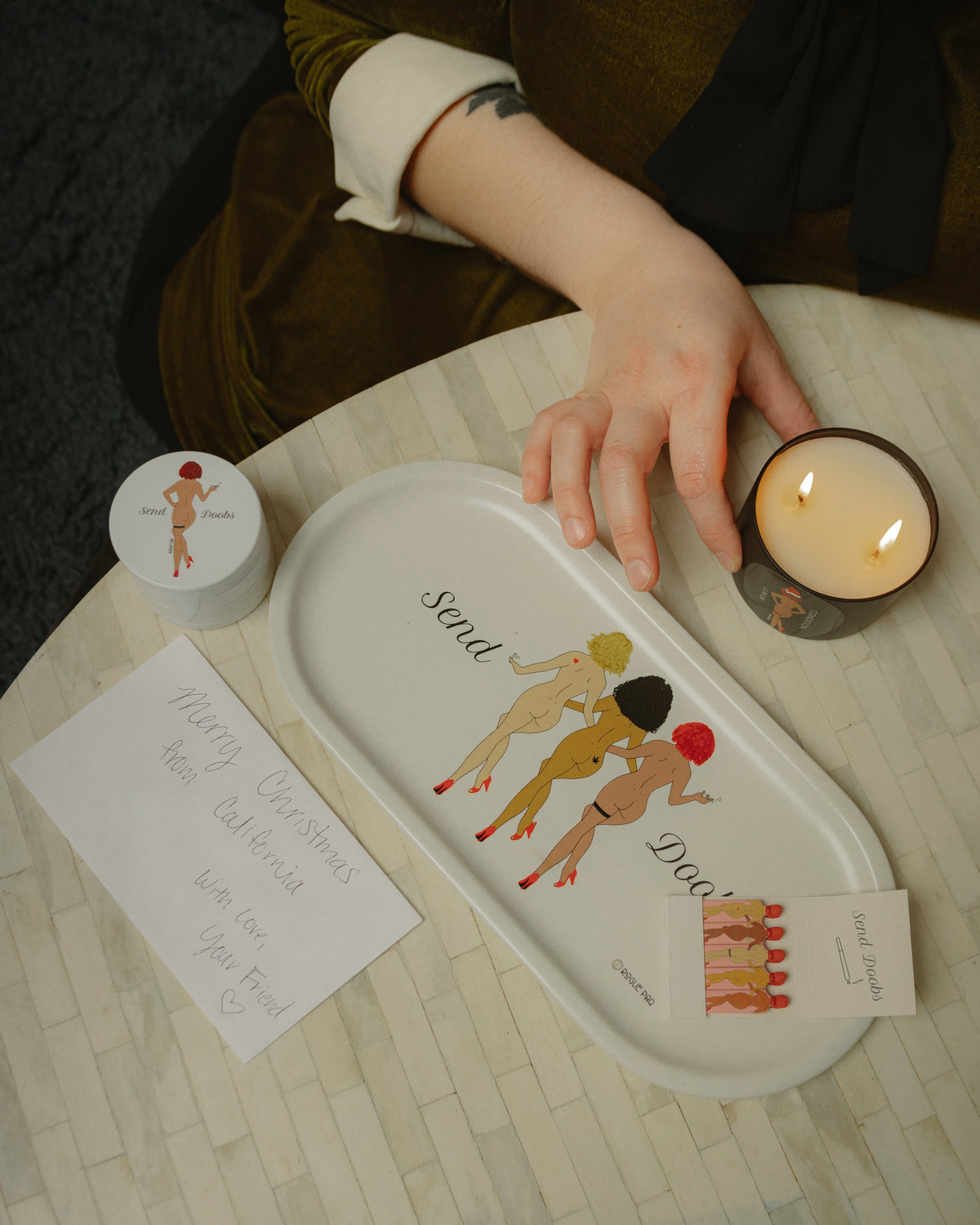 Send Doobs valet tray and grinder set styled as elegant coffee table decor; a functional art piece that celebrates cannabis culture with a wink. Perfect for holiday gifting. 