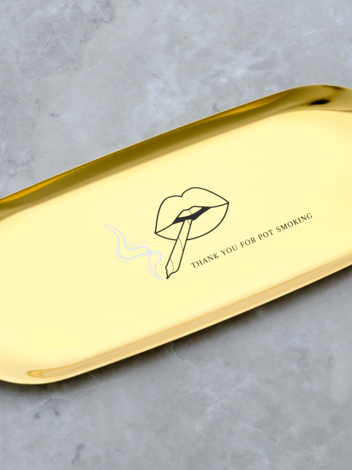 Luxury joint rolling tray perfect for a cannabis ritual. Cute stainless steel rolling tray for travel features pouty lips smoking a joint.