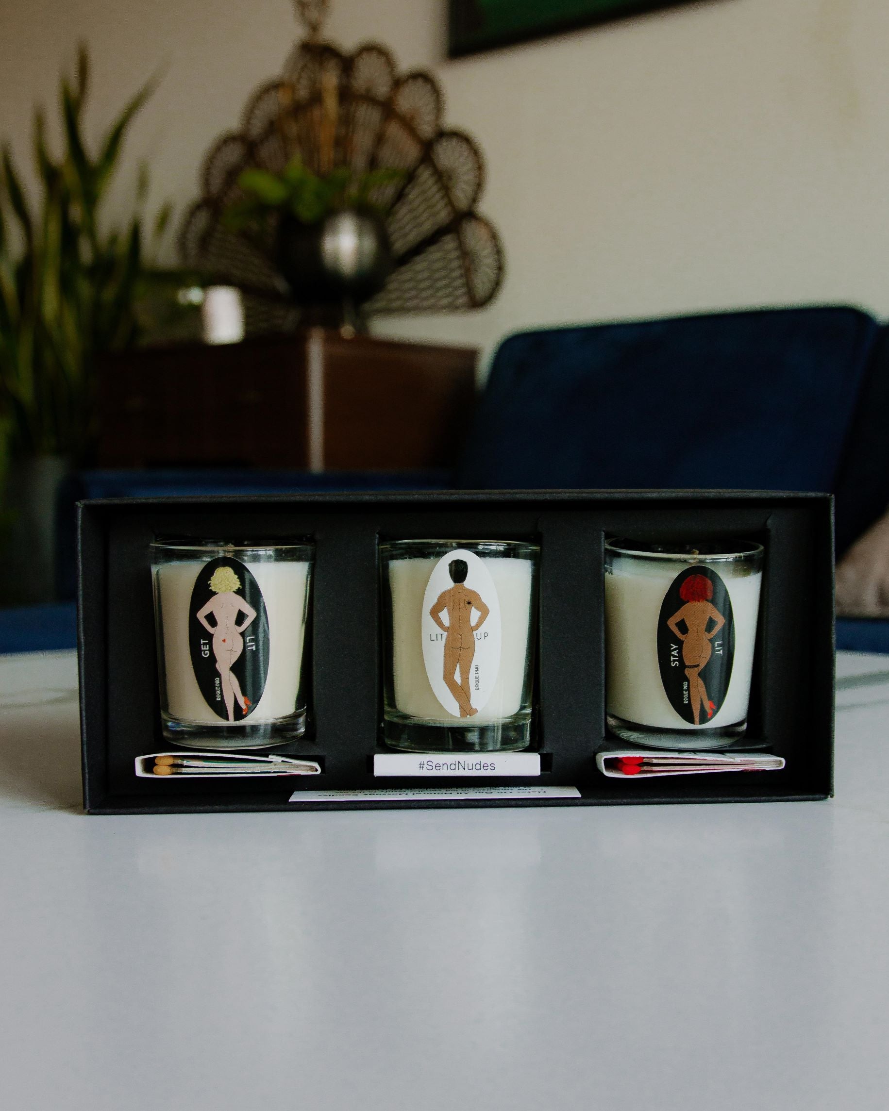 Three organic massage candles and 3 SendNudes matches  in the matte black gift box.