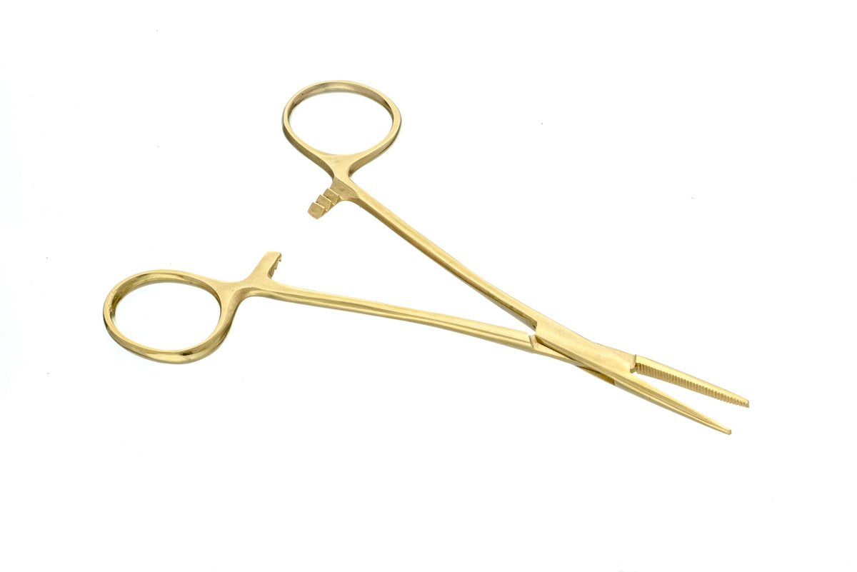A macro shot of the serrated jaws of the gold-toned hemostat. The detail highlights the precision-milled teeth designed to provide a secure, non-slip grip on papers or flower without damaging the delicate materials of the ritual.
