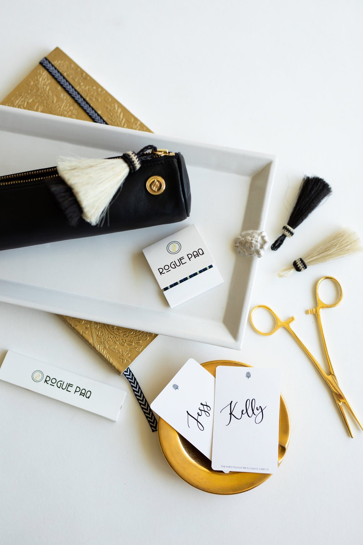The Rogue Paq x KellyGreen leather cannabis case presented on a white ceramic tray. The image highlights the shock-absorbent, thin-padded design of the scent-suppressant bag, curated for a sophisticated and private experience.
