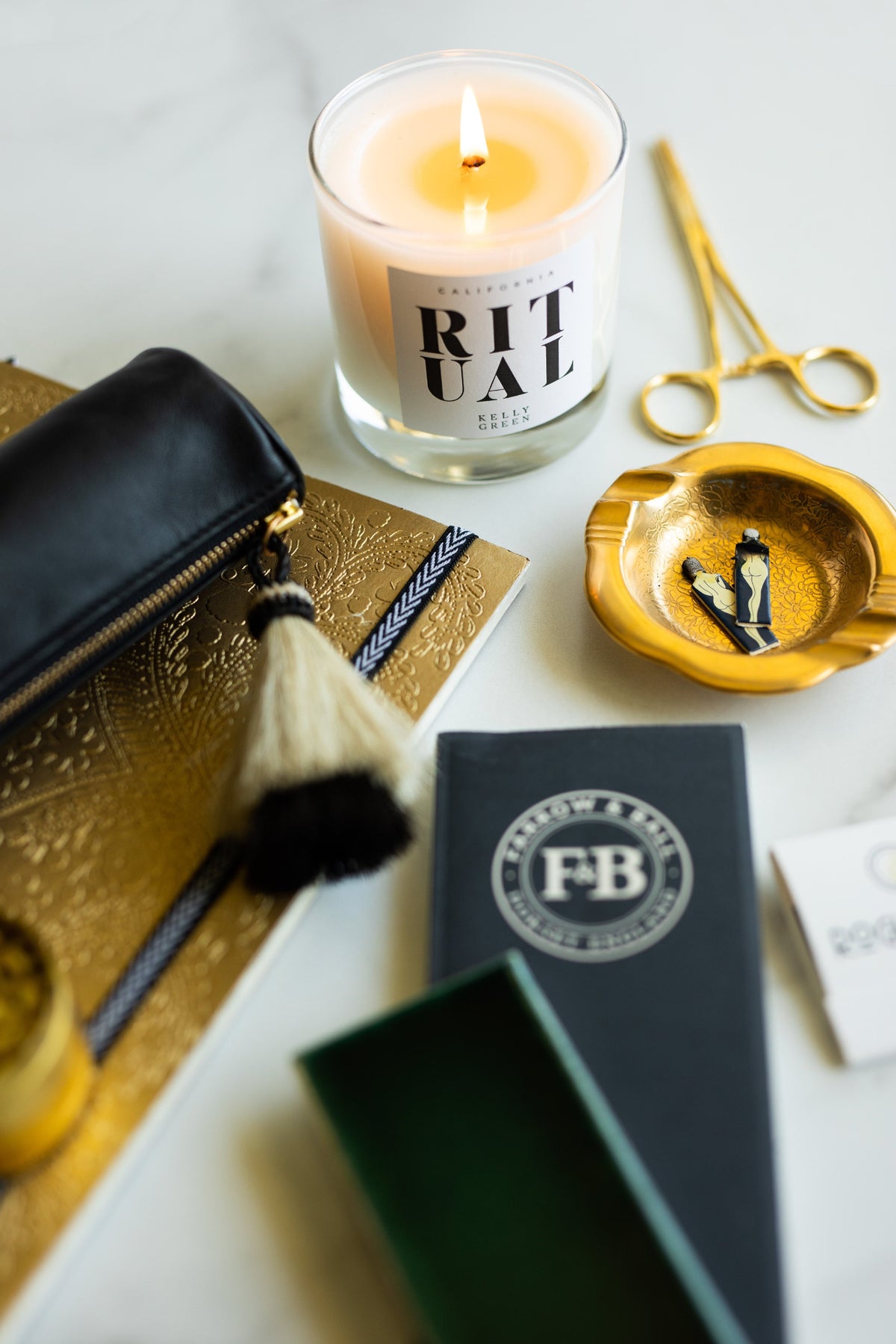 The Rogue Paq x KellyGreen leather cannabis case presented alongside an aromatherapy ritual candle. The image highlights the shock-absorbent, thin-padded design of the scent-suppressant bag, curated for a sophisticated and private experience.