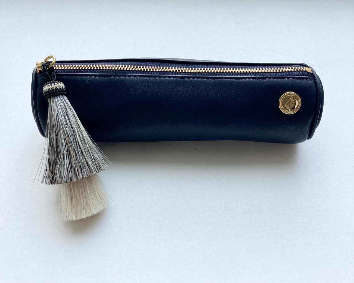 The navy lambskin ritual case presented on a white background. The image highlights the minimalist gold hardware and the durable YKK zipper, showcasing the bag's capacity to hold grinders, vials, and essential ritual tools.