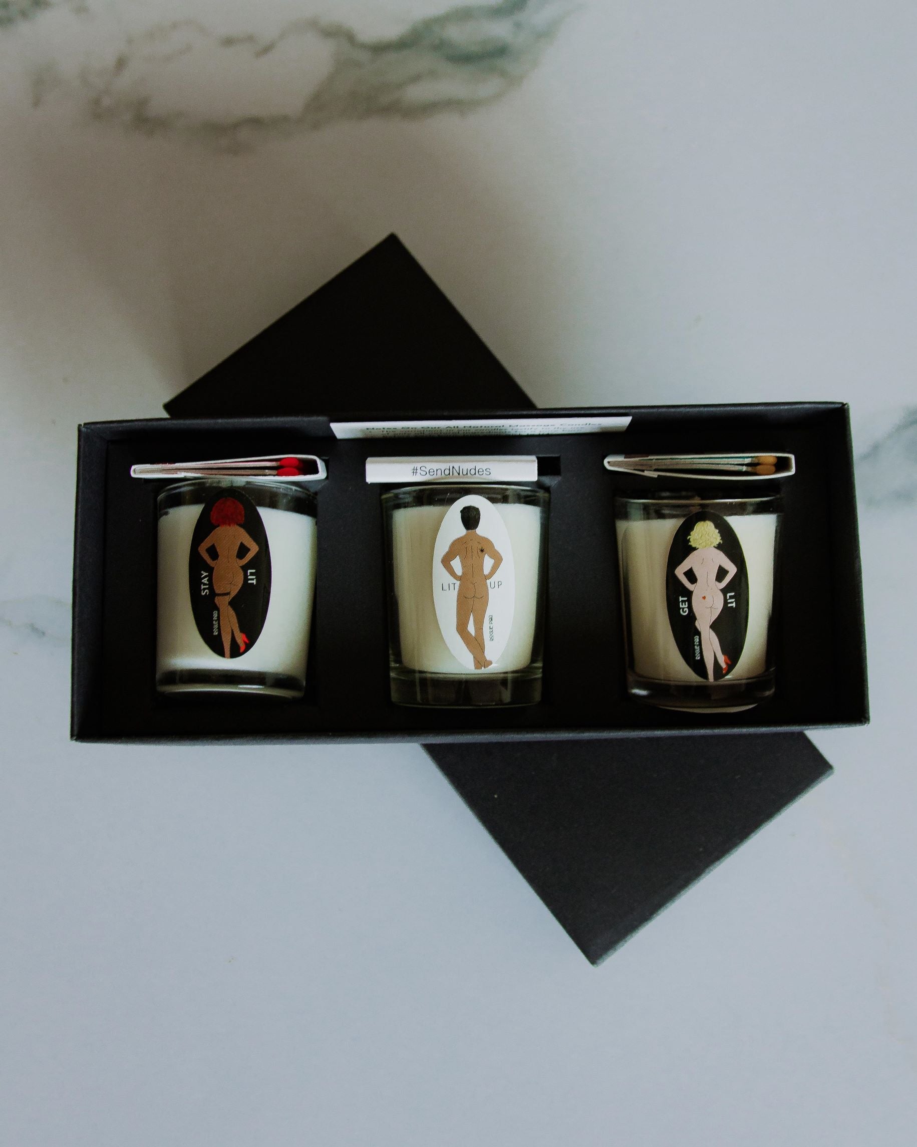 Top down shot of the SendNudes organic aromatherapy gift set with matches.