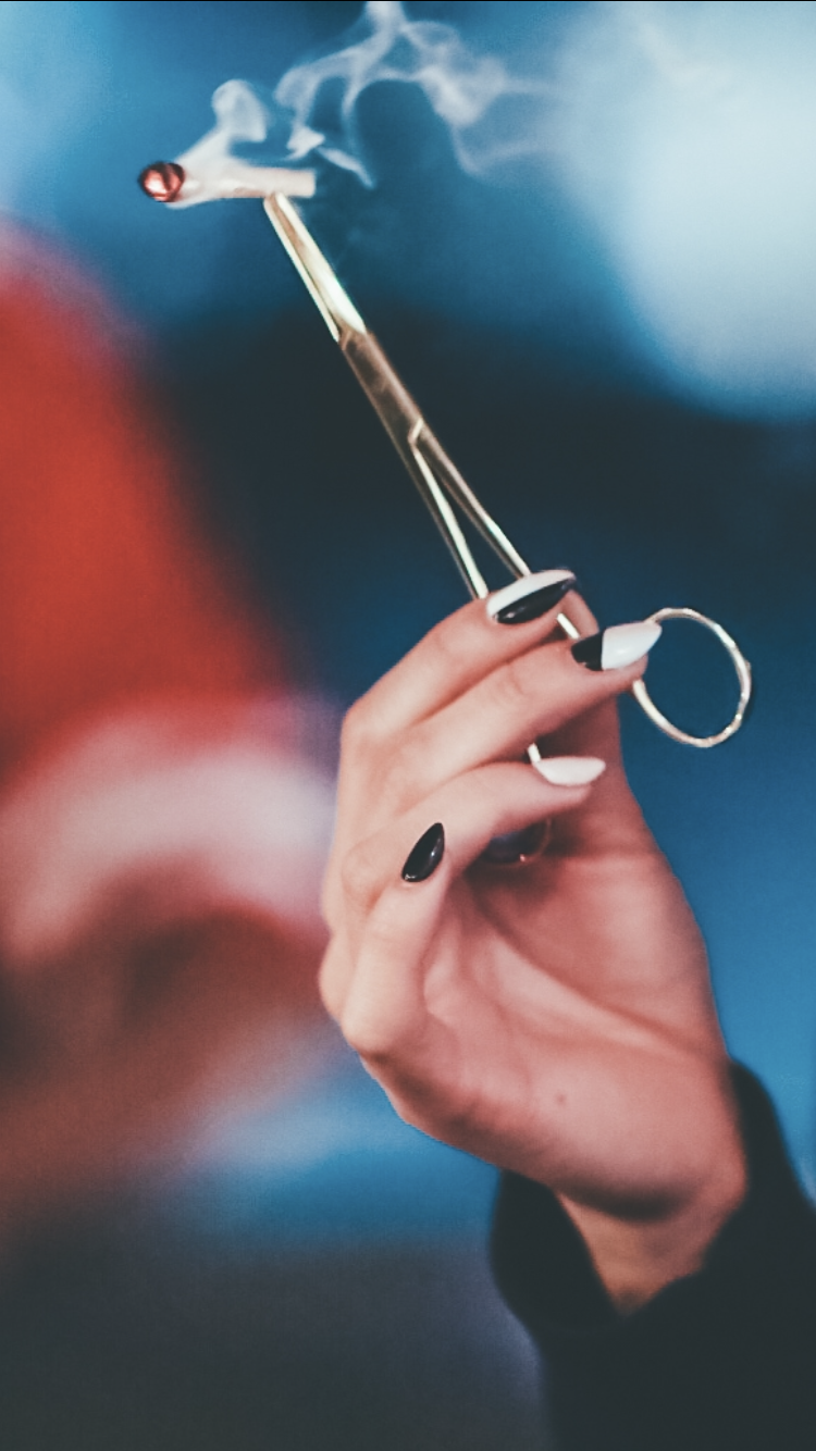 Best Silver Hemostats Joint Clip being held by a female hand. This shows how the tool is used to hold a joint.