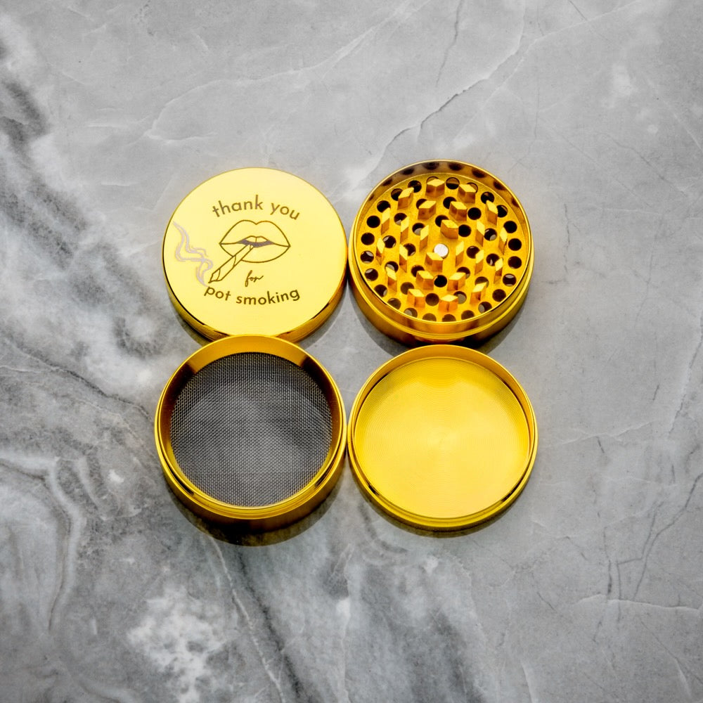 An exploded view showing the four components of the Rogue Paq gold grinder: the magnetic top lid, chamber one with diamond-shaped grinding teeth, the fine-mesh sifting screen, and the bottom kief collection chamber. The interior reveals a high-polish, easy-to-clean finish.